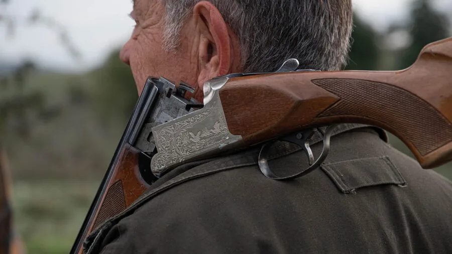Hunter in natural setting demonstrating various specialized game calls for different bird species during hunting