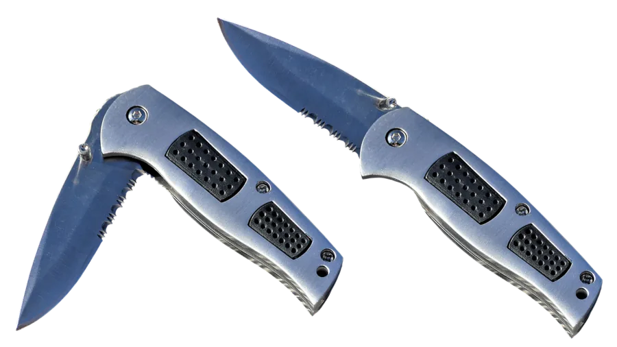 Hunter maintaining and sharpening knife blade outdoors in natural daylight setting