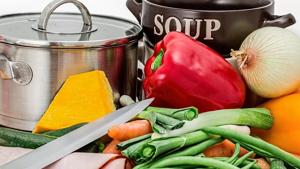 Immersion blender blending ingredients in mixing bowl on kitchen counter