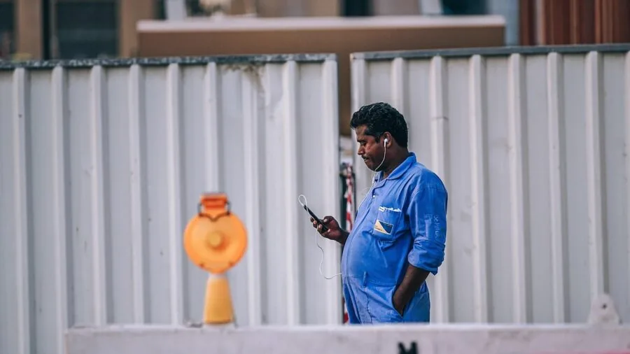 Industrial worker wearing protective gear in a manufacturing facility environment