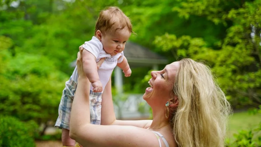 Infant engaging with musical toy through hands-on play and exploration