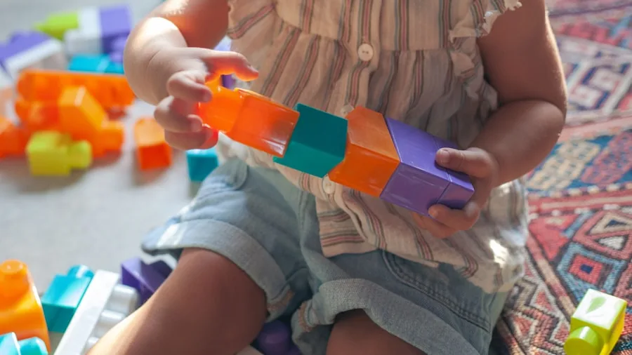 Infant exploring stacking toys with parent supervision in bright nursery environment
