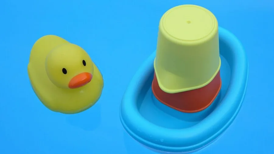 Infant reaching toward bright developmental toys during playtime indoors
