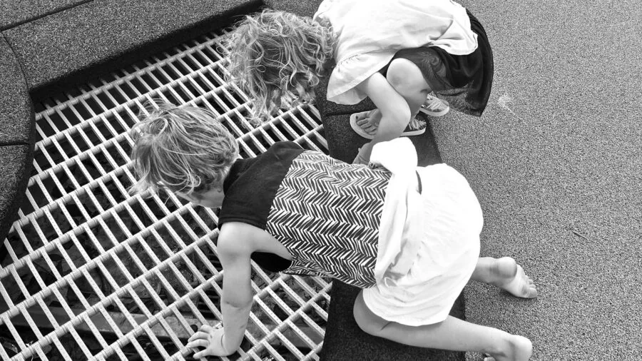 Kids discovering nature while using modern communication devices in an outdoor adventure setting