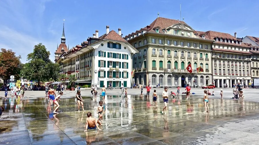 Kids playing together in outdoor water activities during summer day