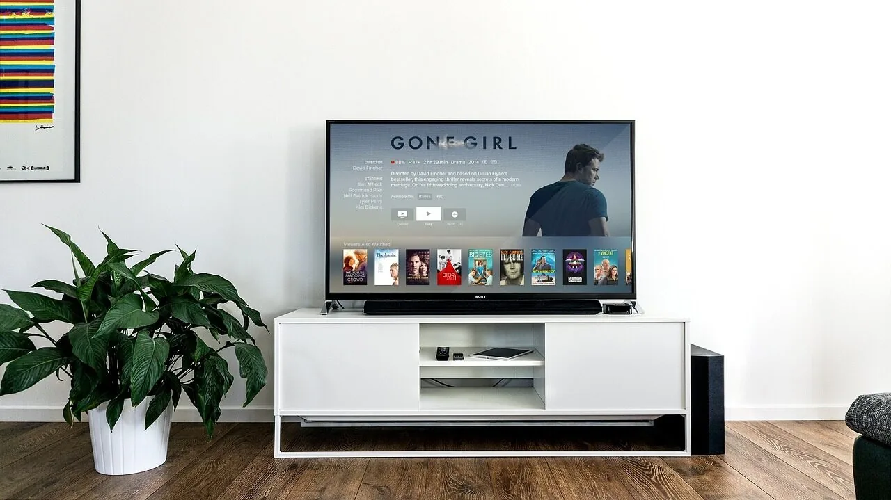 Large 65 inch television mounted on living room wall with clear screen display
