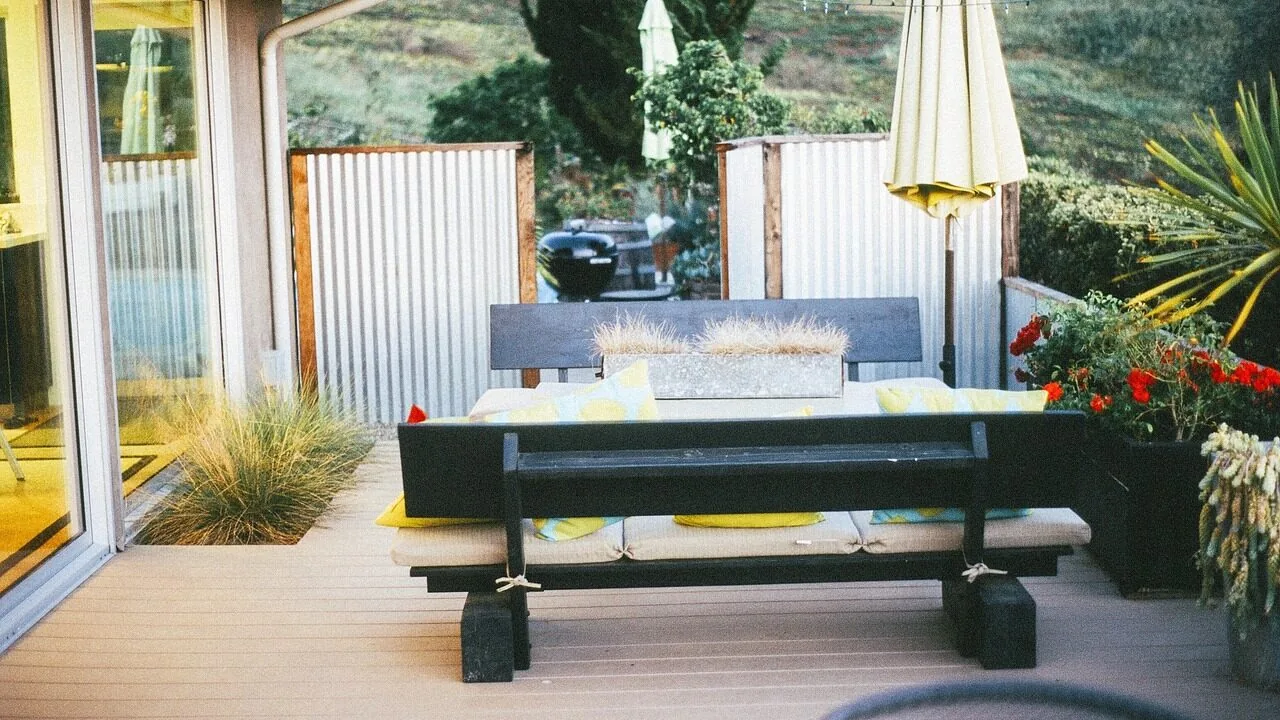 Large patio umbrella providing shade over outdoor deck furniture