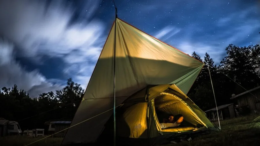LED lighting illuminating tent interior during evening camping trip in wilderness