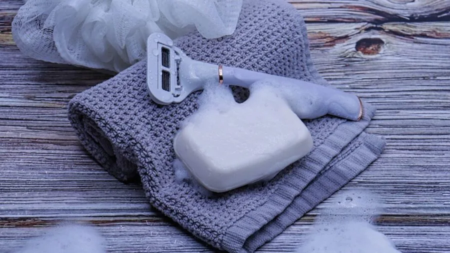 Male traveler packing toiletries and grooming supplies in luggage for international trip