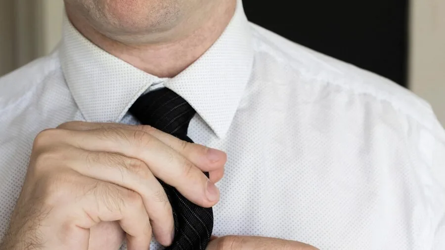 Man applying aftershave or cologne as part of daily grooming routine