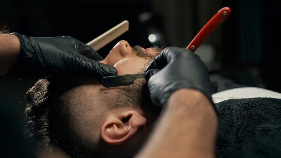 Man applying beard balm as part of daily grooming and facial hair care routine