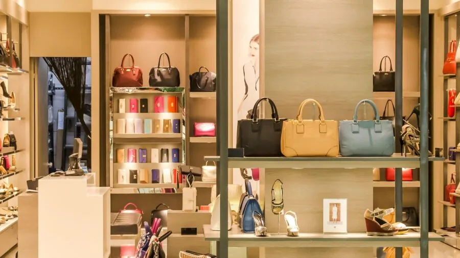 Man browsing cologne options in a modern fragrance shop, comparing products