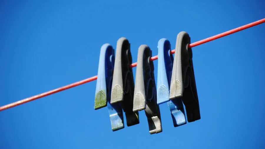 Man doing laundry, carefully washing and checking clothes for durability and quality maintenance