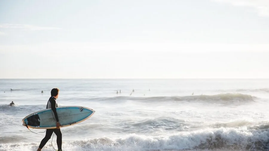 Man enjoying active swimming in ocean waves at beach during daytime