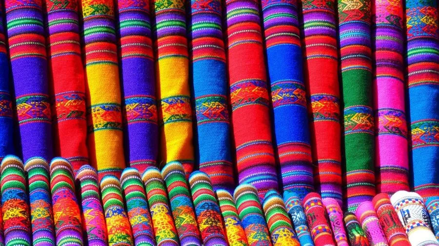 Man examining the texture and feel of soft athletic fabric material in natural daylight