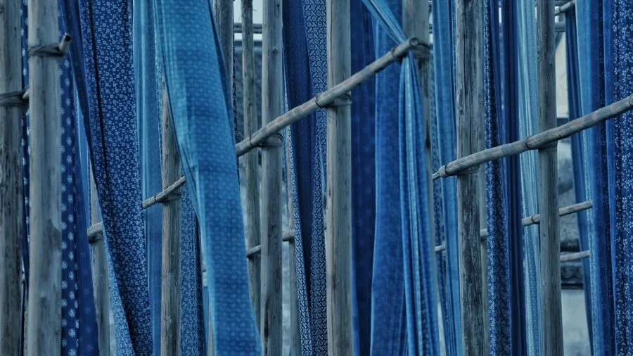Man examining thermal fabric material composition for winter clothing quality and comfort