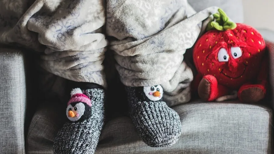 Man in cozy winter socks preparing for cold weather outdoor activities