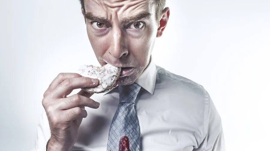 Man in professional dress shirt examining fabric texture and quality in natural lighting