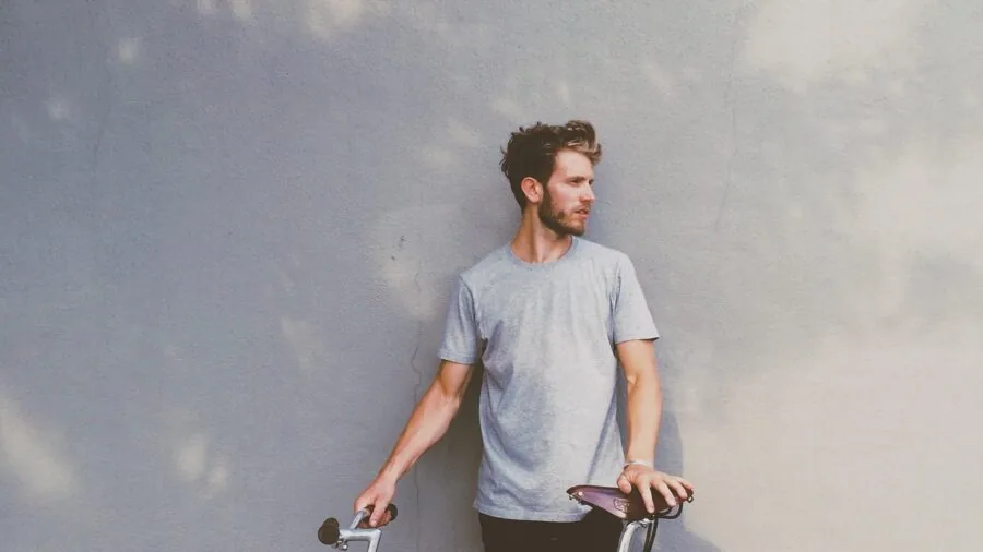 Man in properly fitted casual t-shirt demonstrating quality fit and tailoring on real person