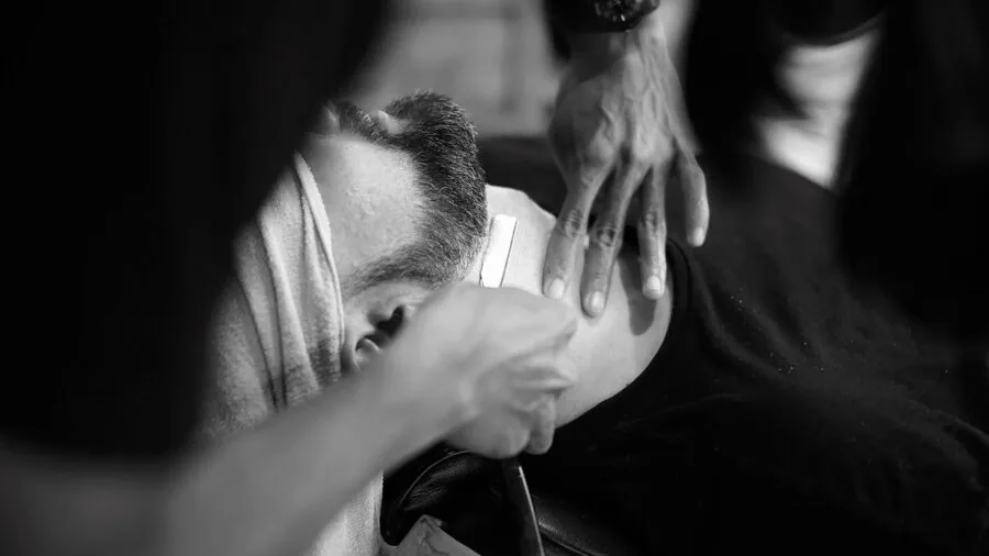 Man preparing skin with shaving products before grooming routine