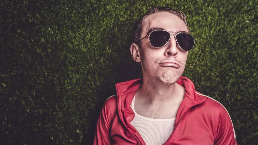 Man shopping for budget-friendly casual wear, examining clothing options in retail environment