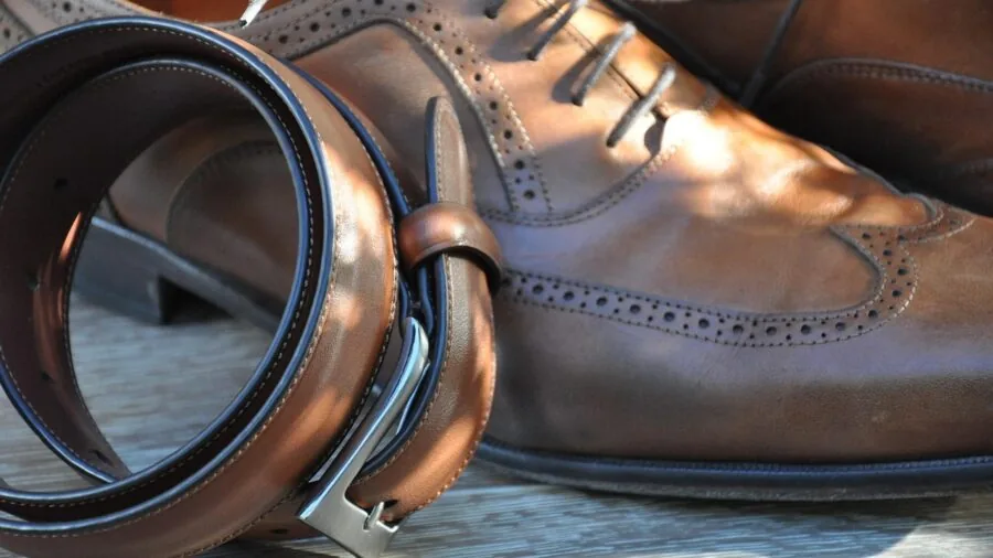 Man sitting while trying on and fitting dress shoes to ensure proper sizing and comfort