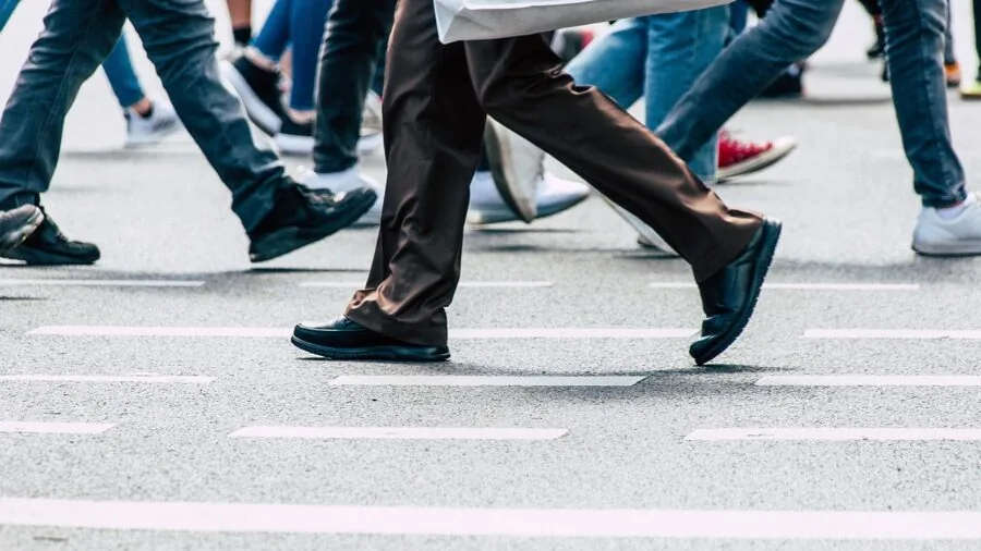 Man walking outdoors on path wearing comfortable walking shoes