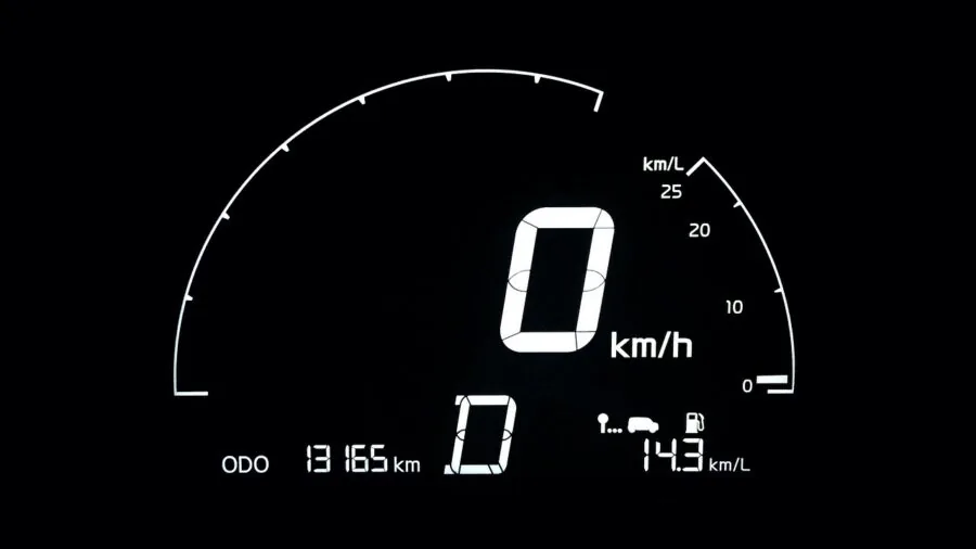 Mechanic installing automotive dashboard gauge in vehicle engine bay during maintenance work