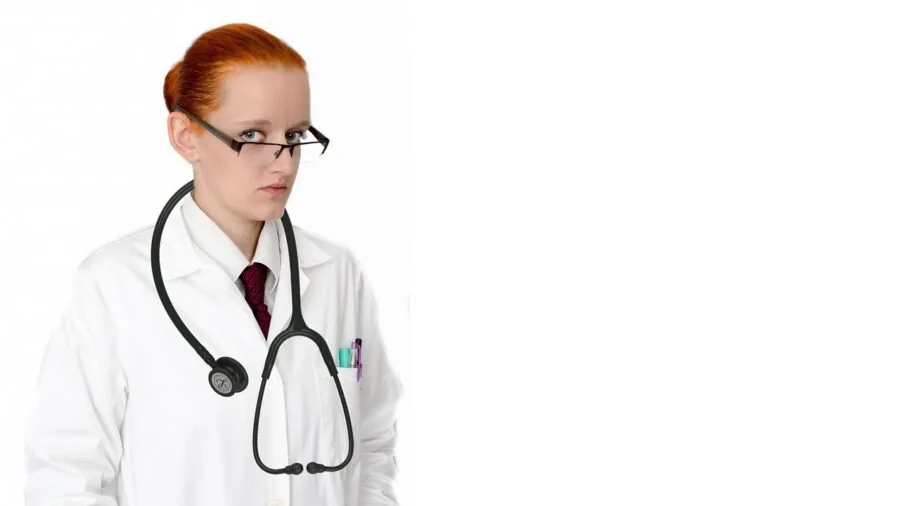 Medical professional rapidly removing lab coat in clinical setting during emergency situation