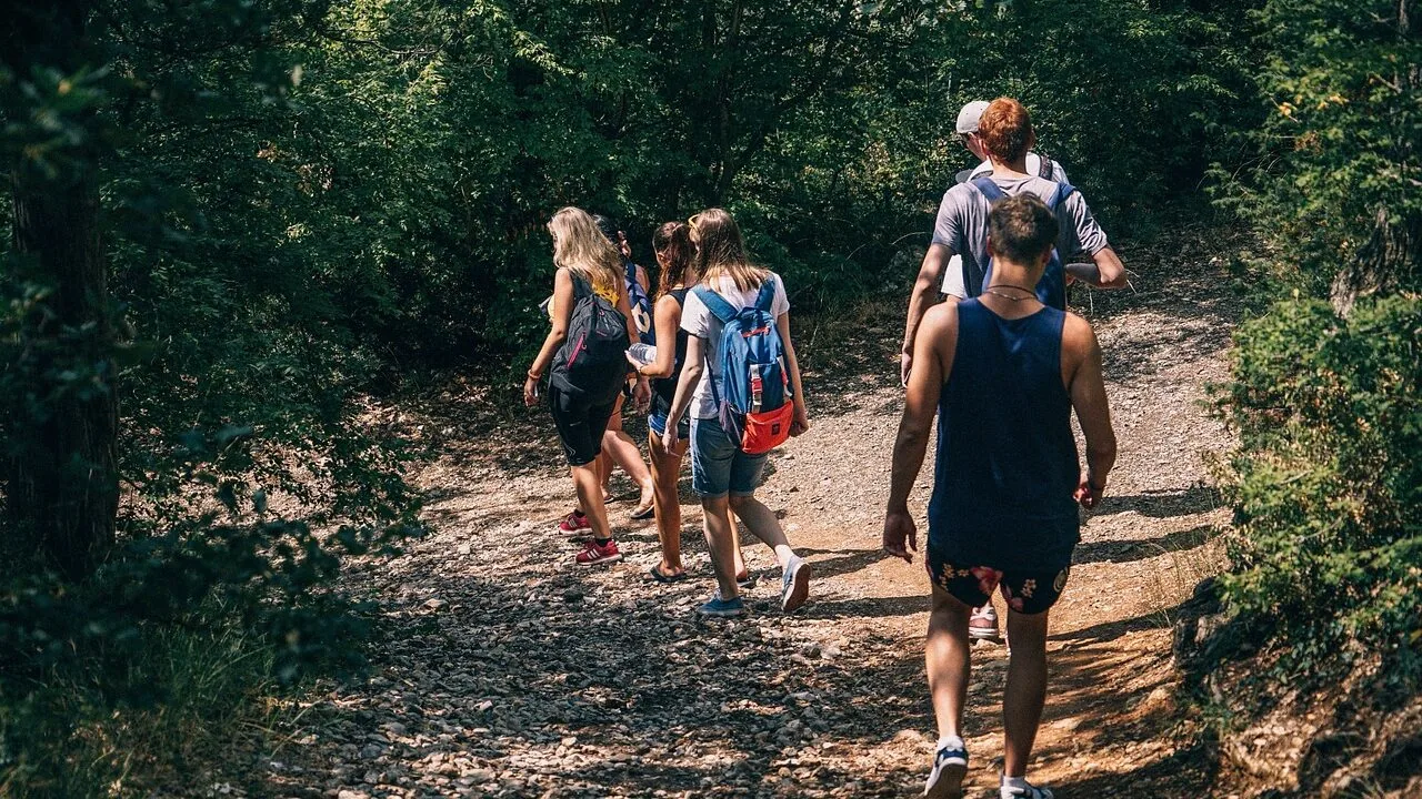 Men's backpack displayed outdoors with hiking gear, clear product focus in landscape orientation