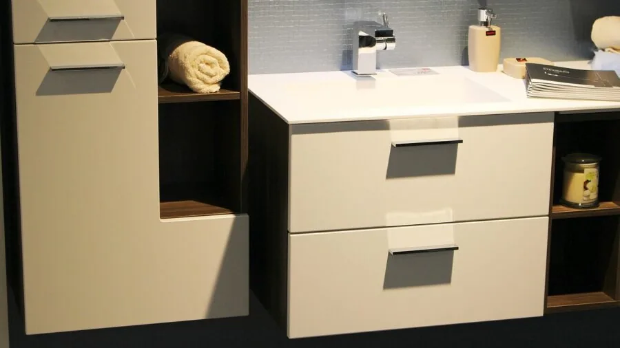 Minimalist bathroom vanity with neutral-toned accessories and organized storage on white marble countertop
