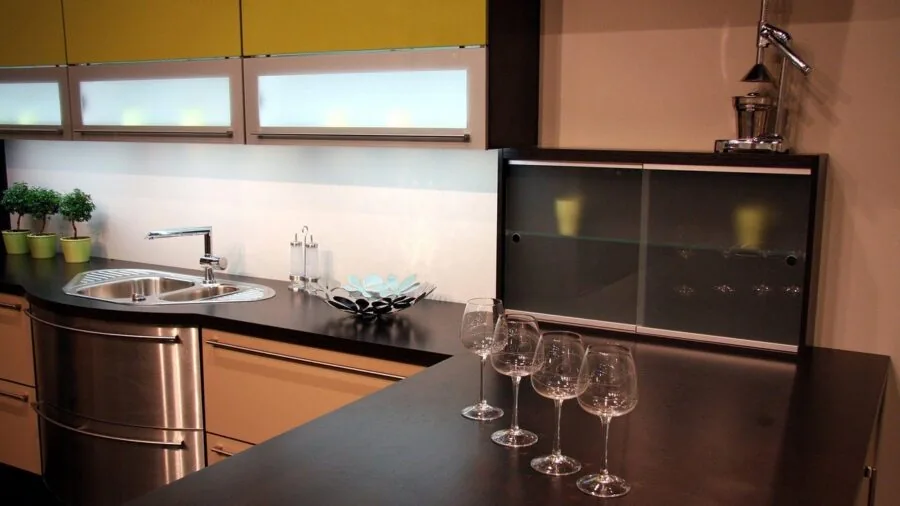 Minimalist kitchen countertop with stainless steel appliances and warm morning light