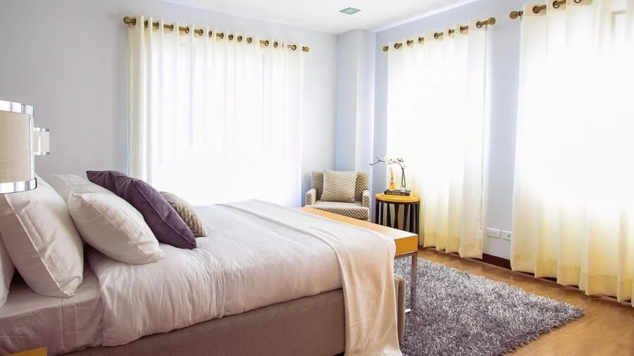 Modern bedroom with natural light showing indoor air quality and home comfort setup