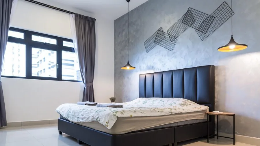 Modern bedroom with upholstered headboard and styled nightstands showing various material textures and finishes
