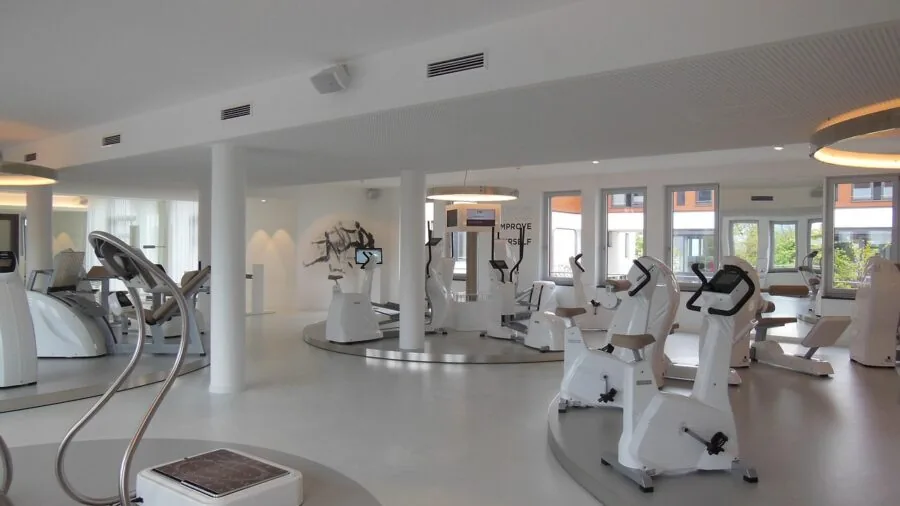 Modern gym interior with protective flooring and exercise equipment setup