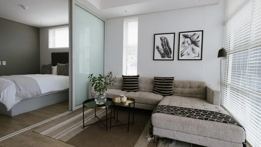 Modern living room showing proper spacing between sofa and coffee table with natural light