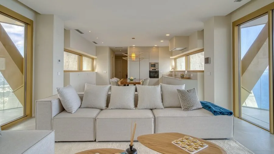 Modern living room with carefully sized area rug anchoring furniture arrangement and defining the open floor plan space