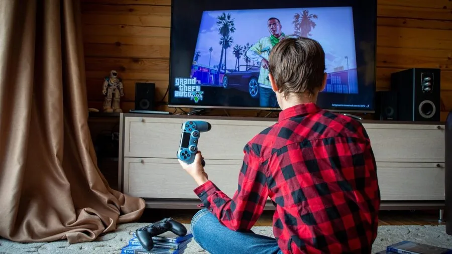 Modern living room with gaming console displayed prominently on entertainment shelf next to television