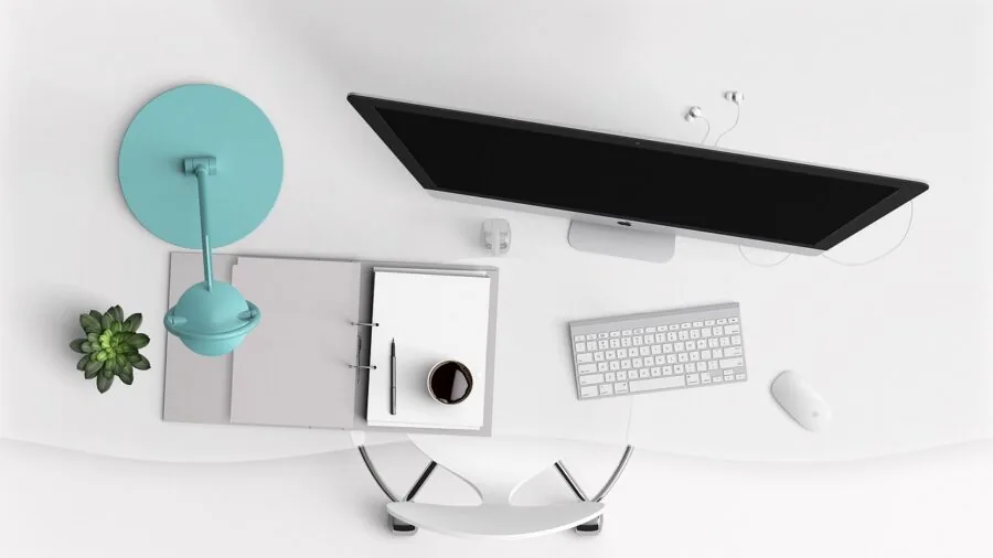 Modern workspace with metallic desk lamp casting warm light over organized work surface