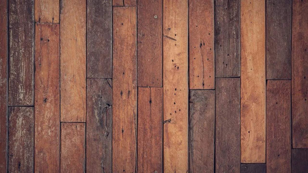 Mop with wet strands cleaning hardwood floor surface