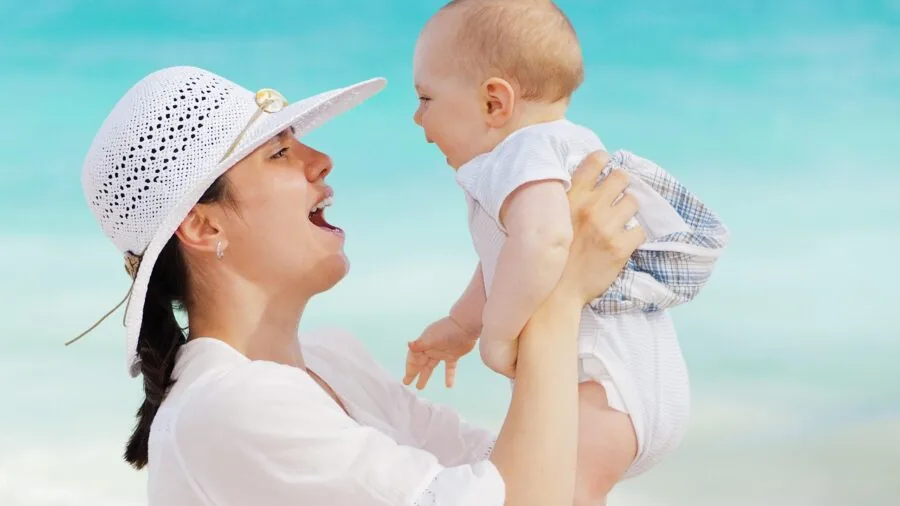 Mother nursing baby in comfortable breathable clothing during warm weather indoors