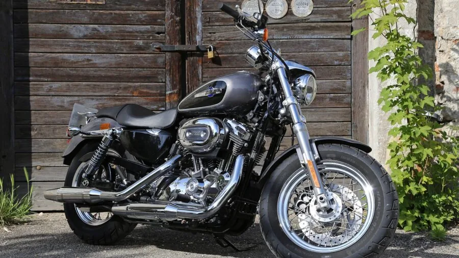 Motorcycle stored outdoors in natural daylight, representing vehicle battery maintenance and preservation