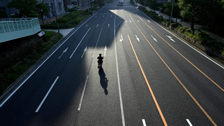 Motorcyclist riding on open highway wearing safety gear and ear protection