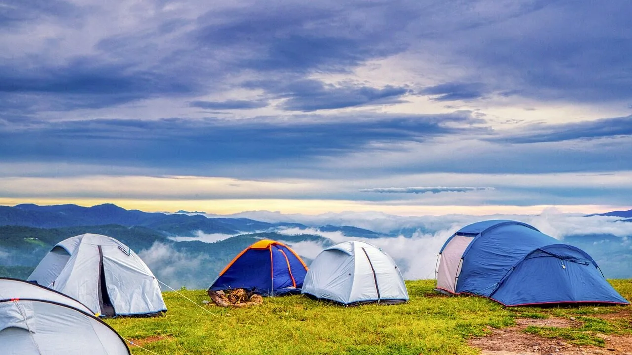 Multiple camping chairs set up at an outdoor campsite