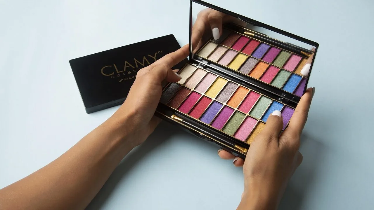 Multiple open eyeshadow palettes showing colorful pigmented shadows and swatches