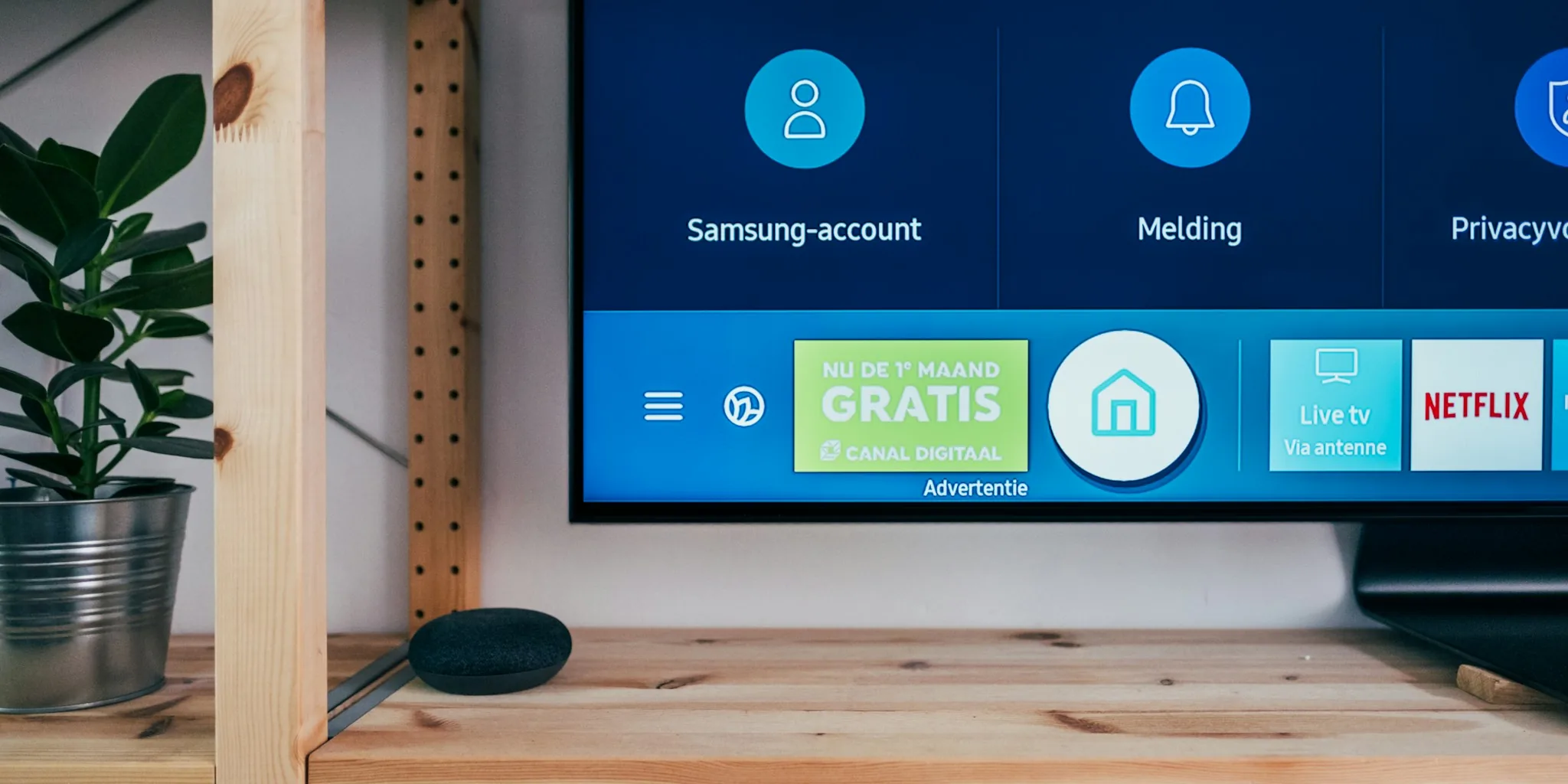 Multiple smart speakers displayed on a shelf in a modern home setting