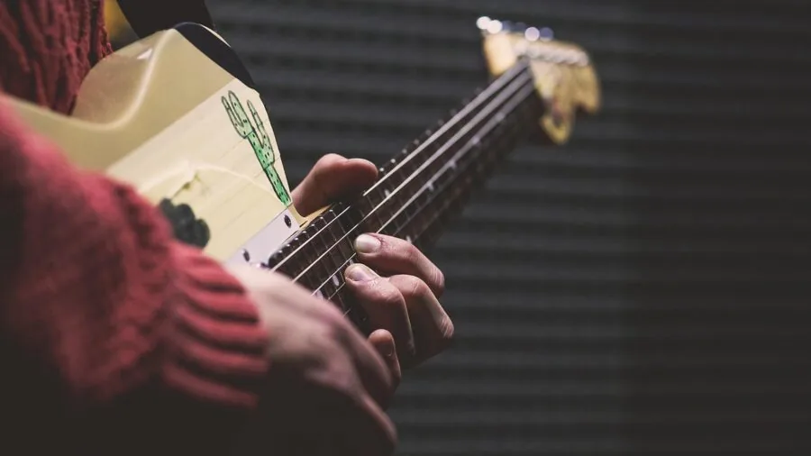 Musician arranging instruments in compact home practice space