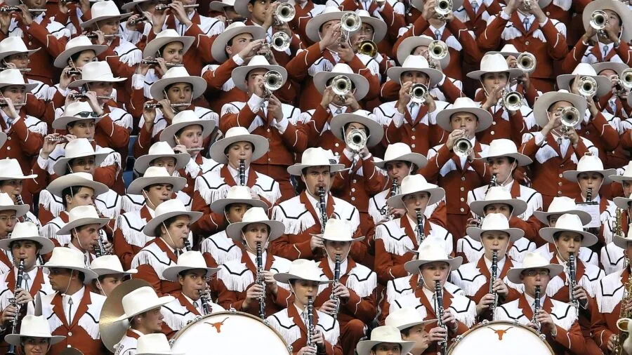 Musician playing trumpet with focused expression during live performance