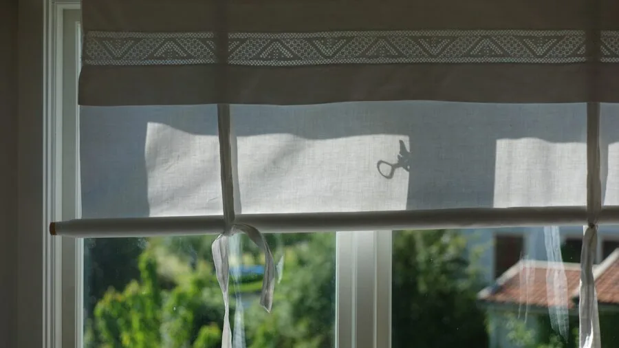 Natural sunlight filtering through lightweight curtains in a bright living room
