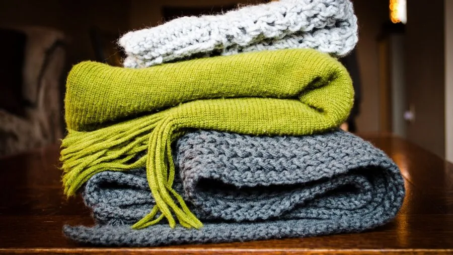 Neatly folded blanket stored in vehicle trunk showing efficient packing and space organization